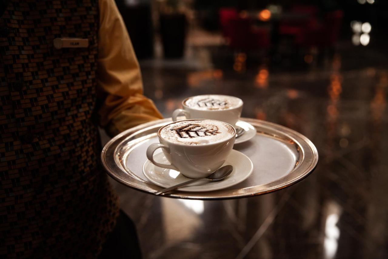 Four Seasons Hotel Rijád Exteriér fotografie A waiter serving coffee